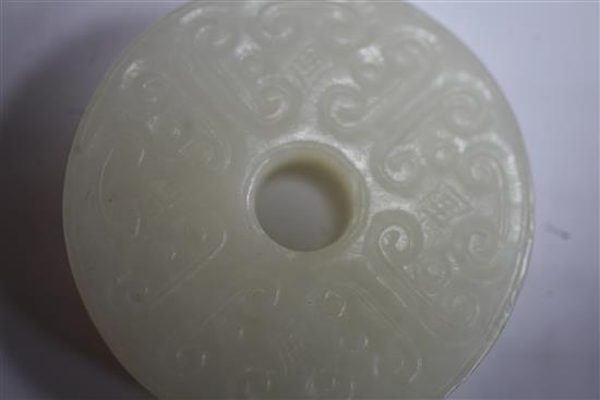 A Chinese white jade bi disc, diameter 4.6cm, wood stand